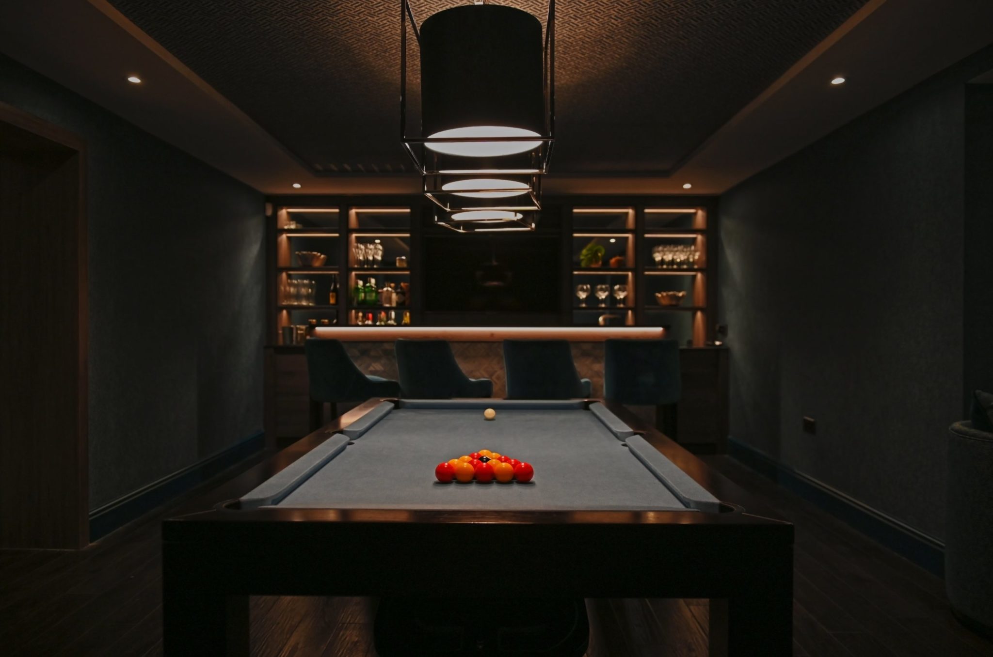 a pool table in a dimly lit room.