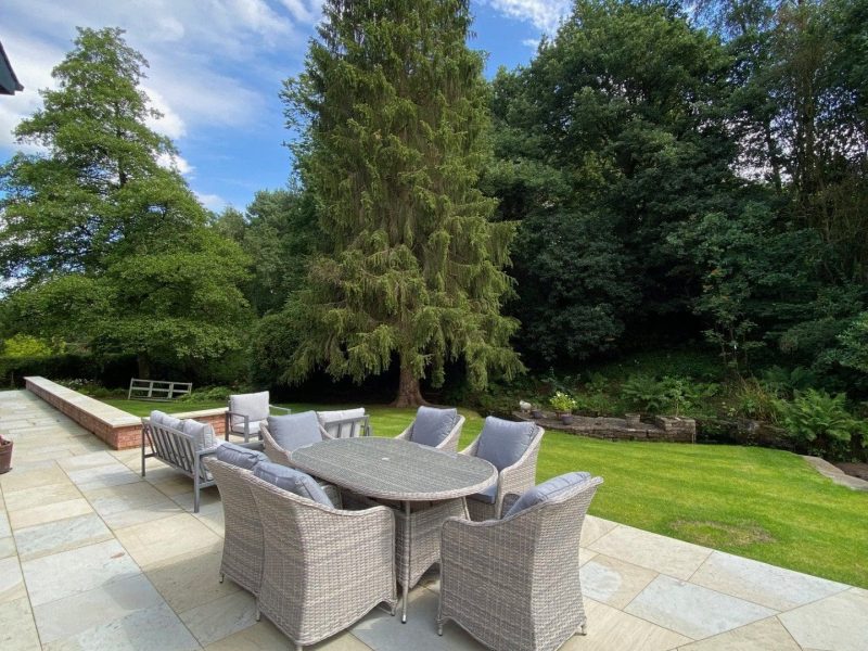 A large patio with a table and chairs.