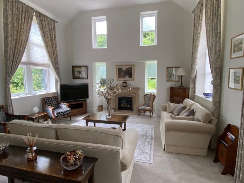 A large living room with couches and a fireplace.