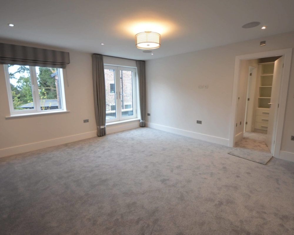 a empty room with a large window and a door.