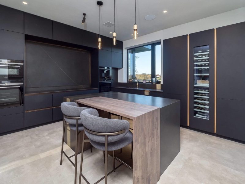 a kitchen with a center island and two stools.