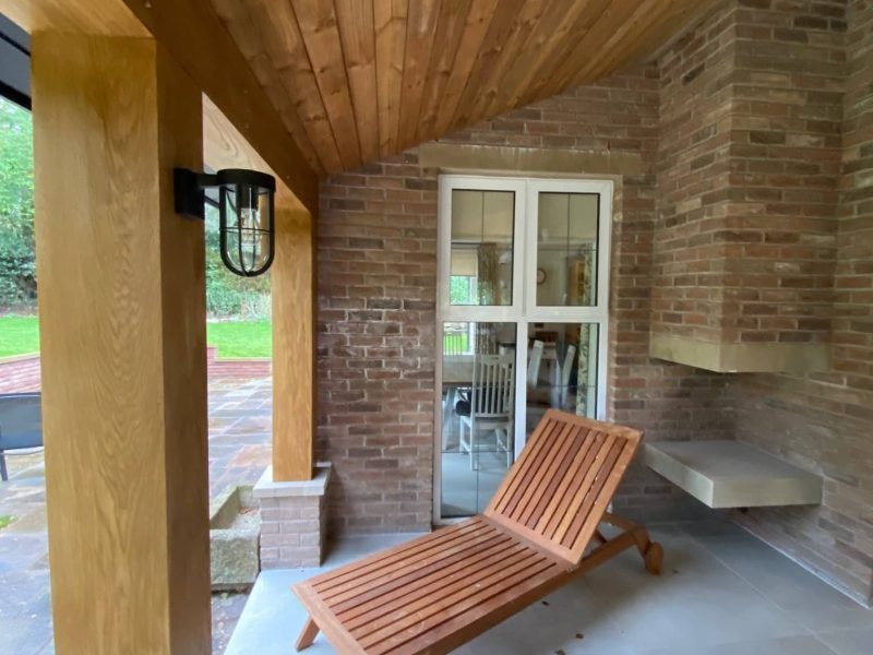 a wooden bench sitting on top of a patio.