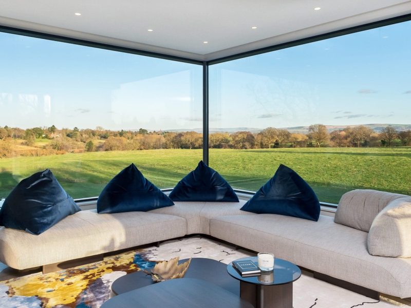 a living room filled with furniture and a large window.