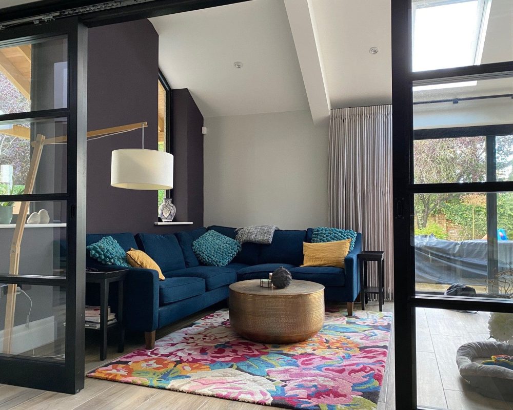 a living room filled with furniture and a large window.