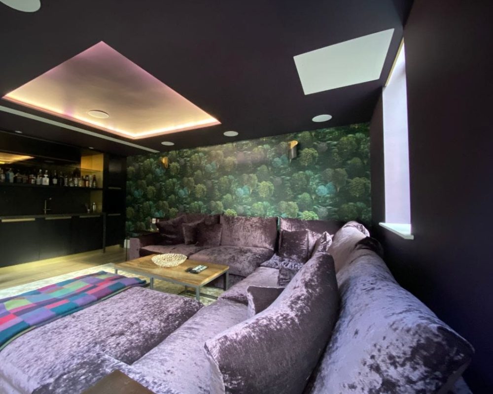 a living room filled with furniture and a large painting on the wall.