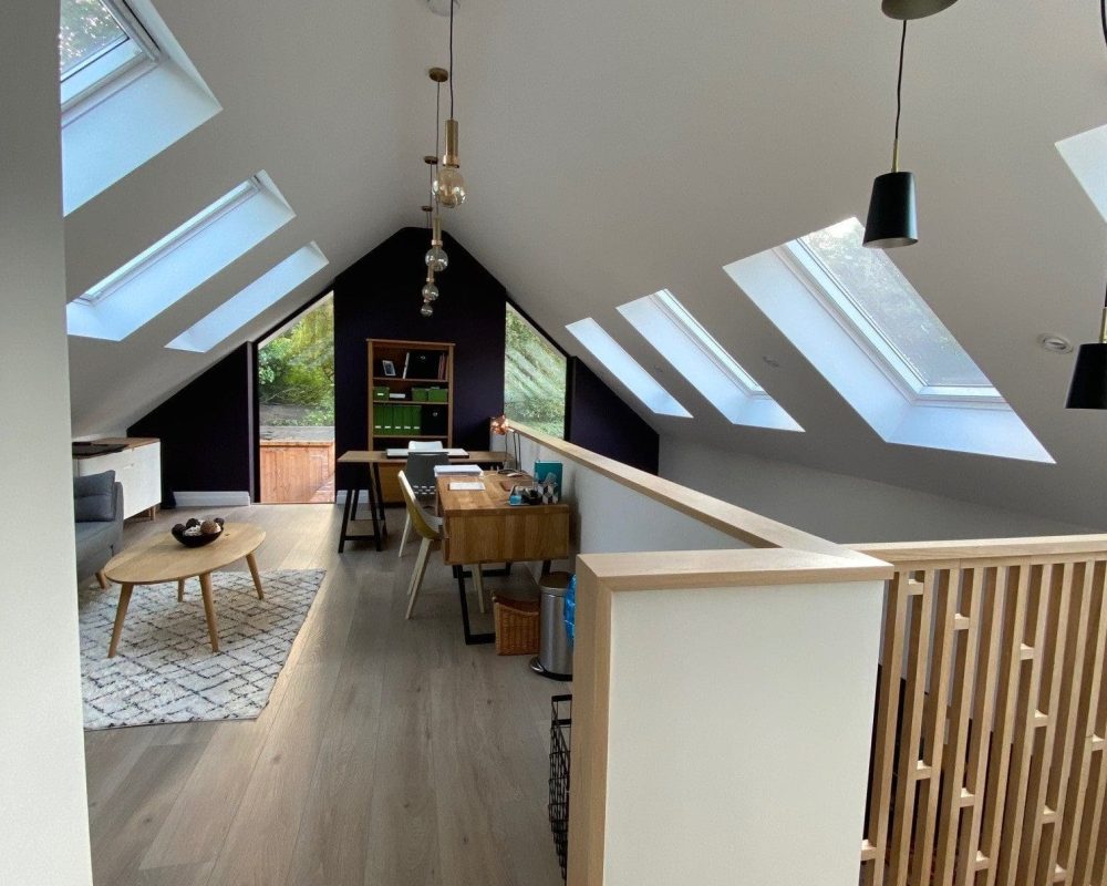 a living room with a staircase leading up to a loft.