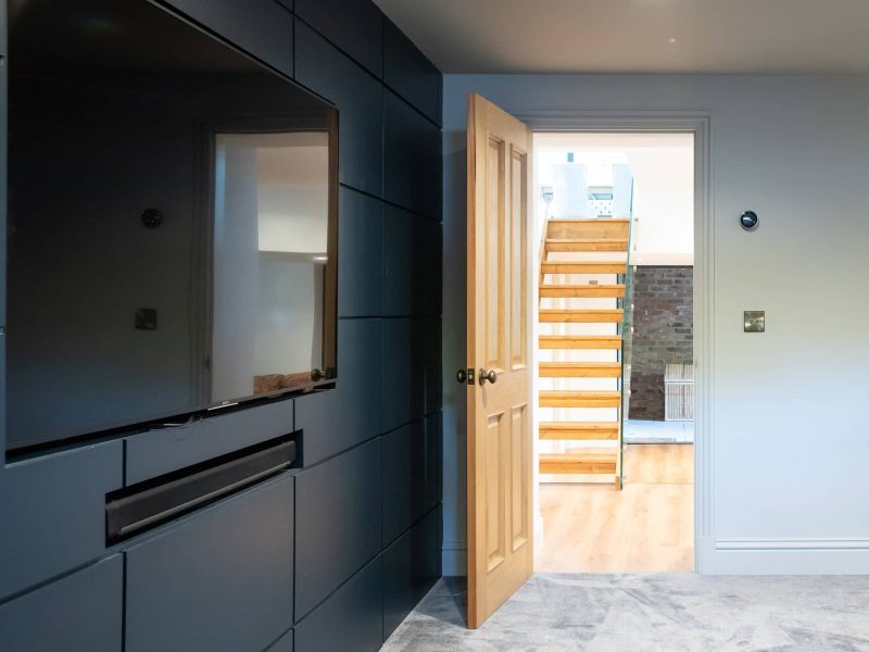 an open door leading to a room with a staircase.