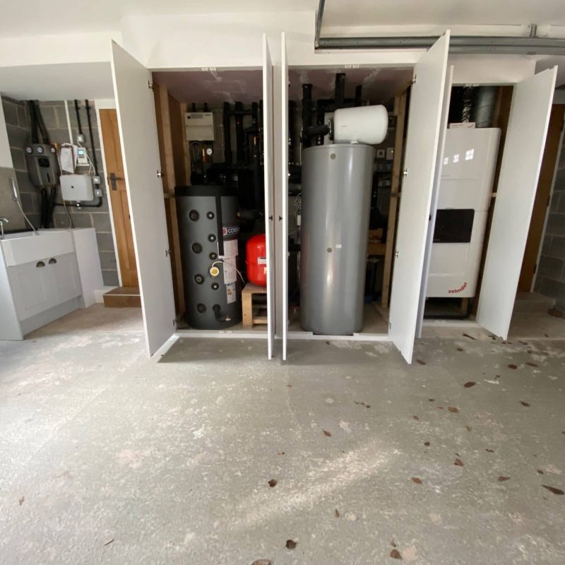 A bathroom with a hot water heater in it.